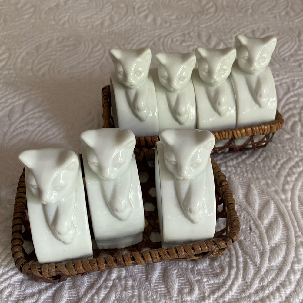 Porcelain cat napkin rings in woven basket